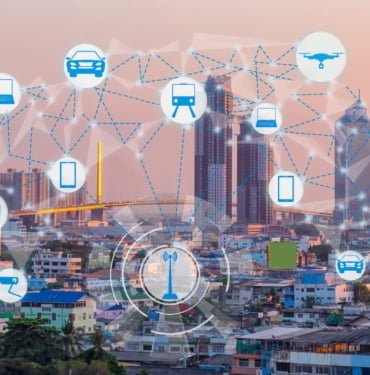 Internet of Things and Smart city concept. Smart things icons mesh on cityscape background.