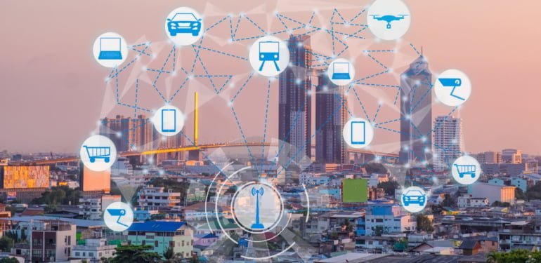 Internet of Things and Smart city concept. Smart things icons mesh on cityscape background.