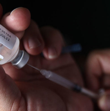 A nurse prepares a H1N1 influenza vaccine during the start of a campaign against the influenza at a hospital in Tegucigalpa