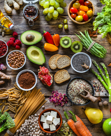Vegan food backgrounds: large group of fruits, vegetables, cereals and spices shot from above
