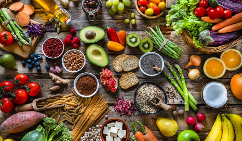 Vegan food backgrounds: large group of fruits, vegetables, cereals and spices shot from above